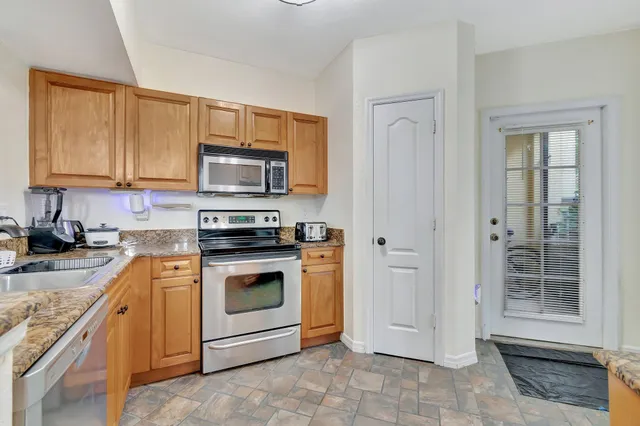 a kitchen with stainless steel appliances granite countertop a sink and cabinets