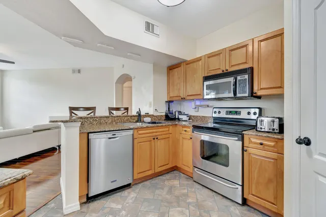 a view of kitchen with furniture and refrigerator