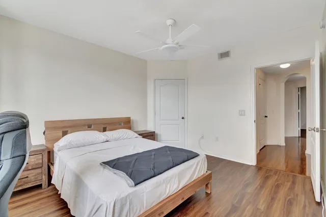 a bathroom with a granite countertop sink toilet and shower curtains