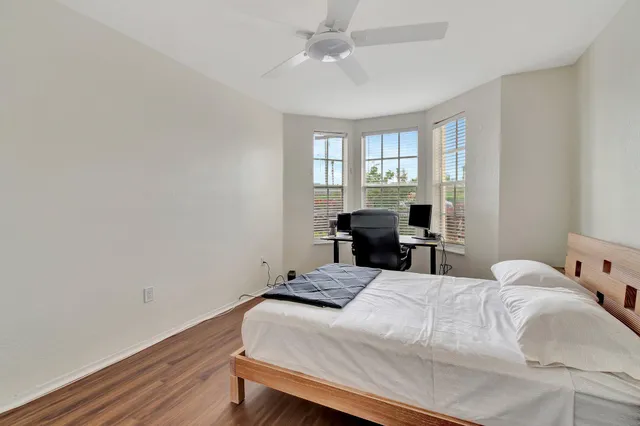 a bathroom with a granite countertop toilet a sink and a shower