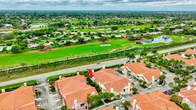 an aerial view of a house with garden space and lake view