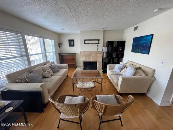 a living room with furniture and a fireplace