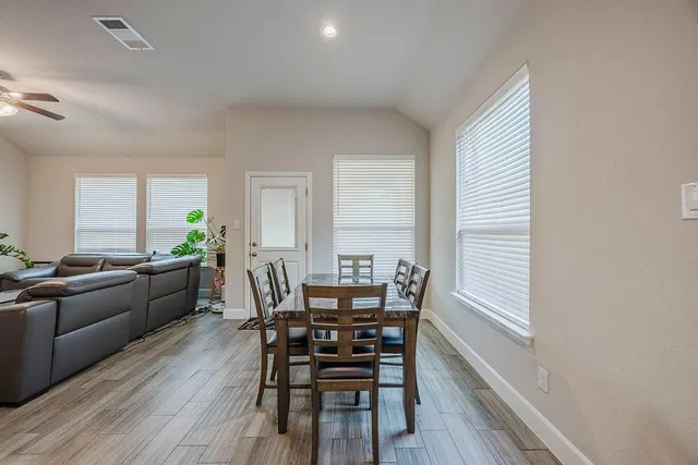 a view of a dining room with furniture and wooden floor