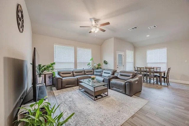 a living room with furniture potted plant and a window