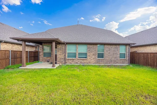 a view of a house with a yard and porch