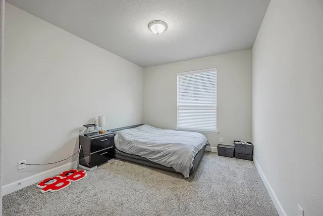 a bedroom with a bed and a table