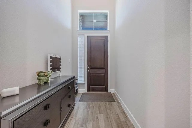 a kitchen with a sink and wooden floor