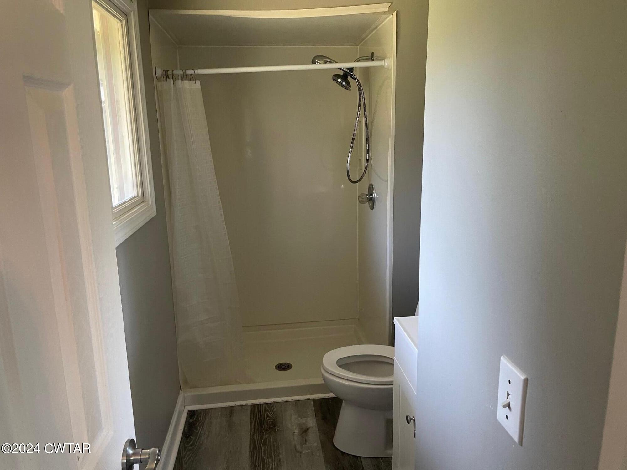 113 Ebenezer Road Mercer, TN 38392 - Photo 13 of 36 a bathroom with a toilet and shower