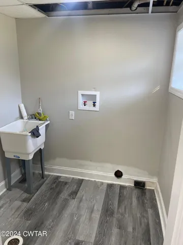 a view of a room with wooden floor