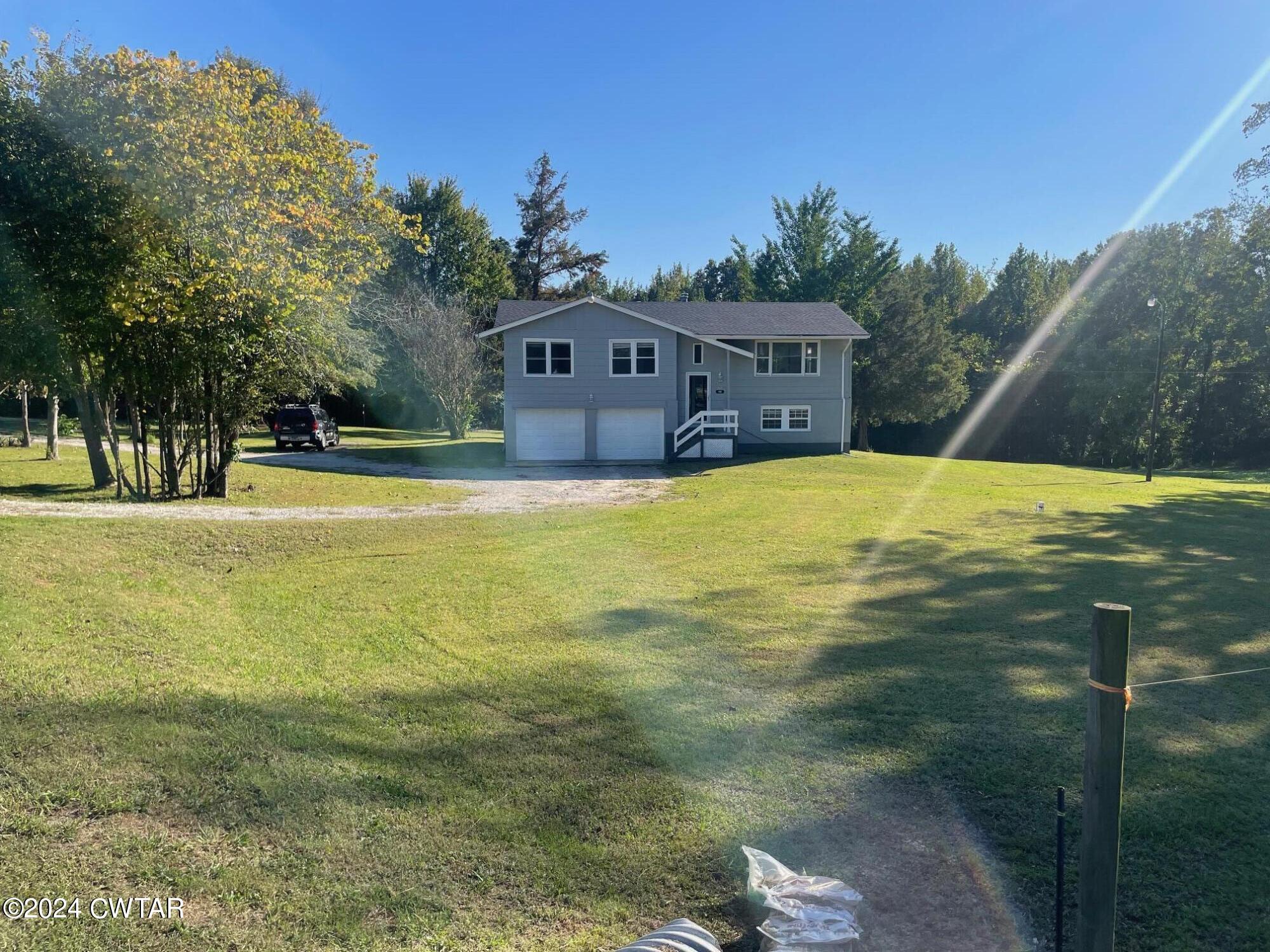 113 Ebenezer Road Mercer, TN 38392 - Photo 2 of 36 a swimming pool with trees in the background