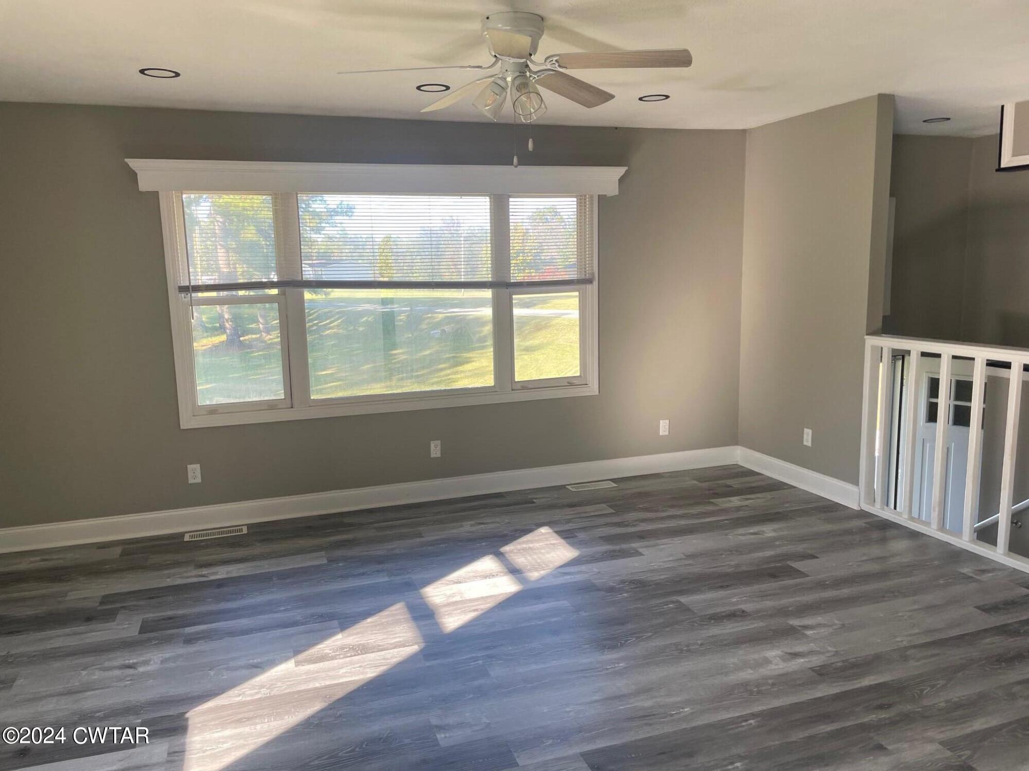 113 Ebenezer Road Mercer, TN 38392 - Photo 7 of 36 an empty room with wooden floor and windows