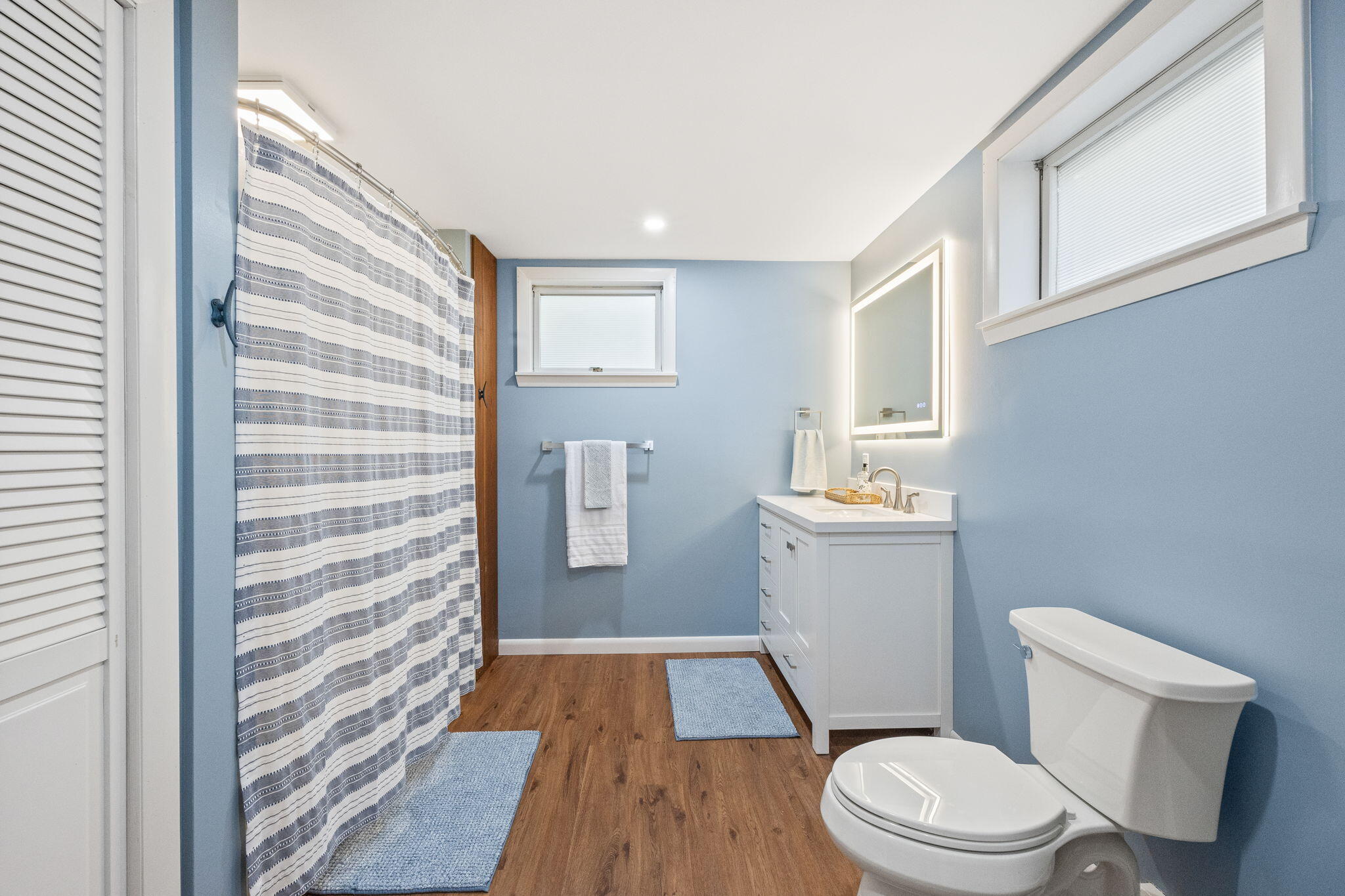 6 Deer Path Truro, MA 02666 - Photo 30 of 41 a white toilet sitting next to a bathroom sink and vanity