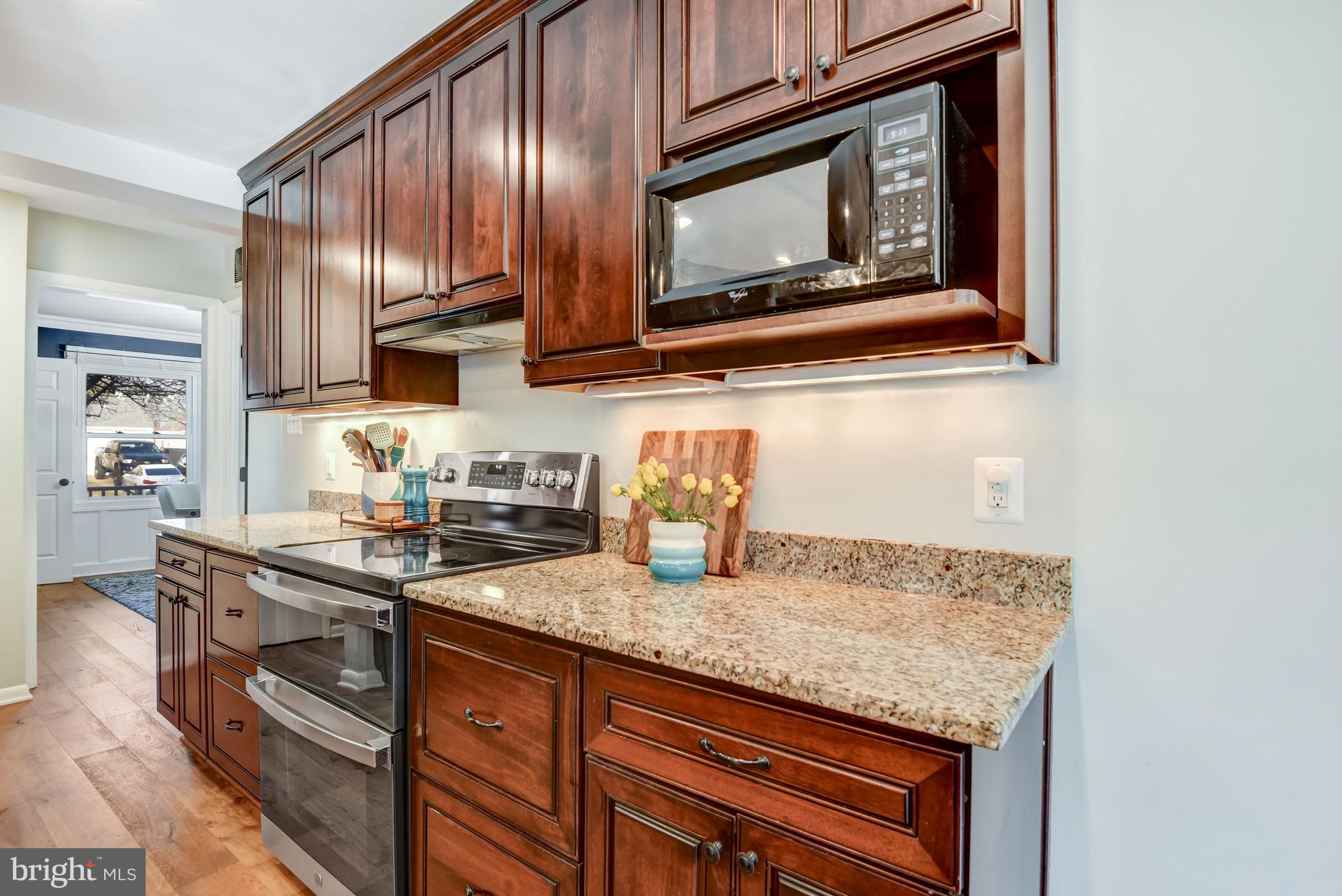 13631 Ellendale Drive Chantilly, VA 20151 - Photo 27 of 54 a kitchen with granite countertop stainless steel appliances a stove sink and microwave