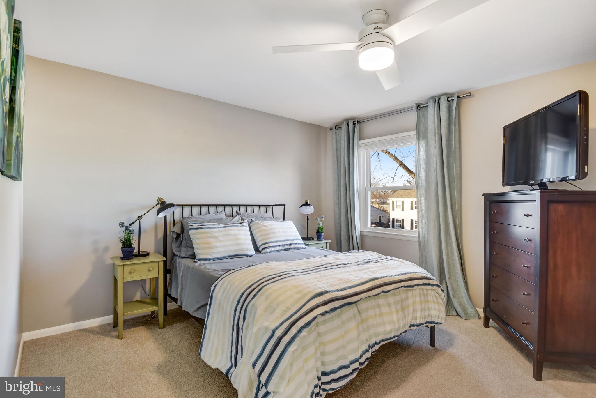 13631 Ellendale Drive Chantilly, VA 20151 - Photo 36 of 54 a bedroom with a bed and a flat tv screen on a dresser