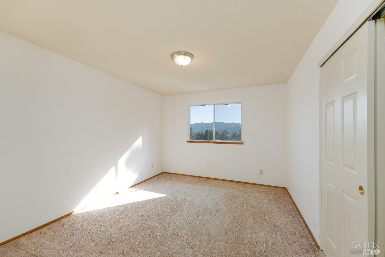 27841 Poppy Drive Willits, CA 95490 - Photo 13 of 17 an empty room with a empty space and windows