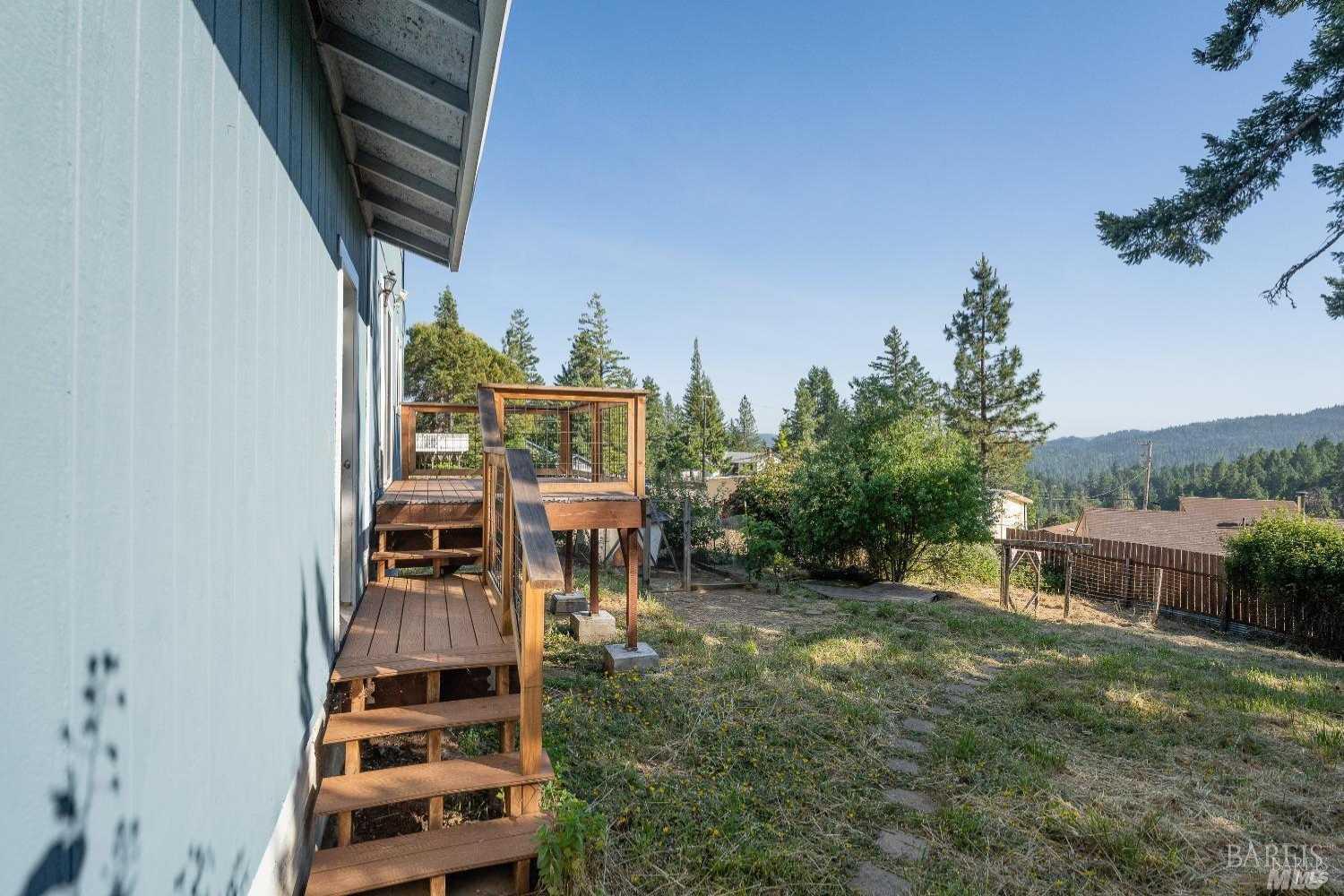 27841 Poppy Drive Willits, CA 95490 - Photo 16 of 17 a balcony with table and chairs and potted plants