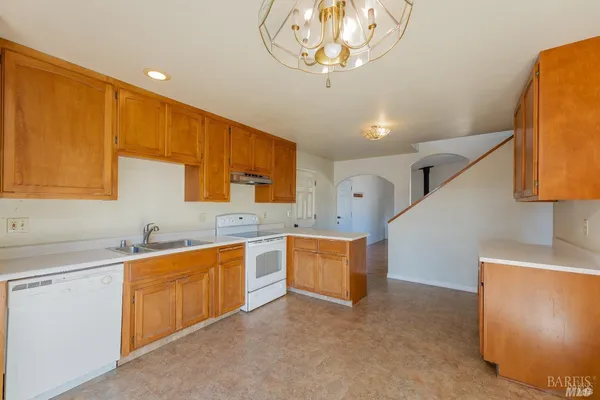 a front view of house with yard and trees around