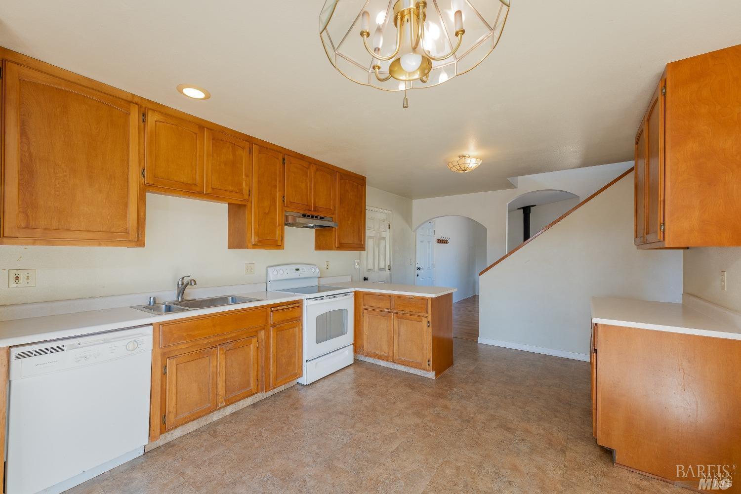 27841 Poppy Drive Willits, CA 95490 - Photo 2 of 17 a kitchen with stainless steel appliances a sink dishwasher stove refrigerator and couches