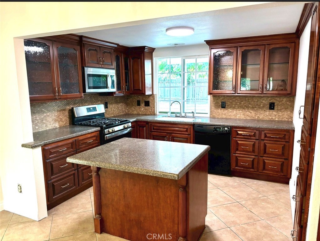 1164 Massachusetts Avenue Riverside, CA 92507 - Photo 5 of 14 a kitchen with stainless steel appliances granite countertop a sink stove and microwave