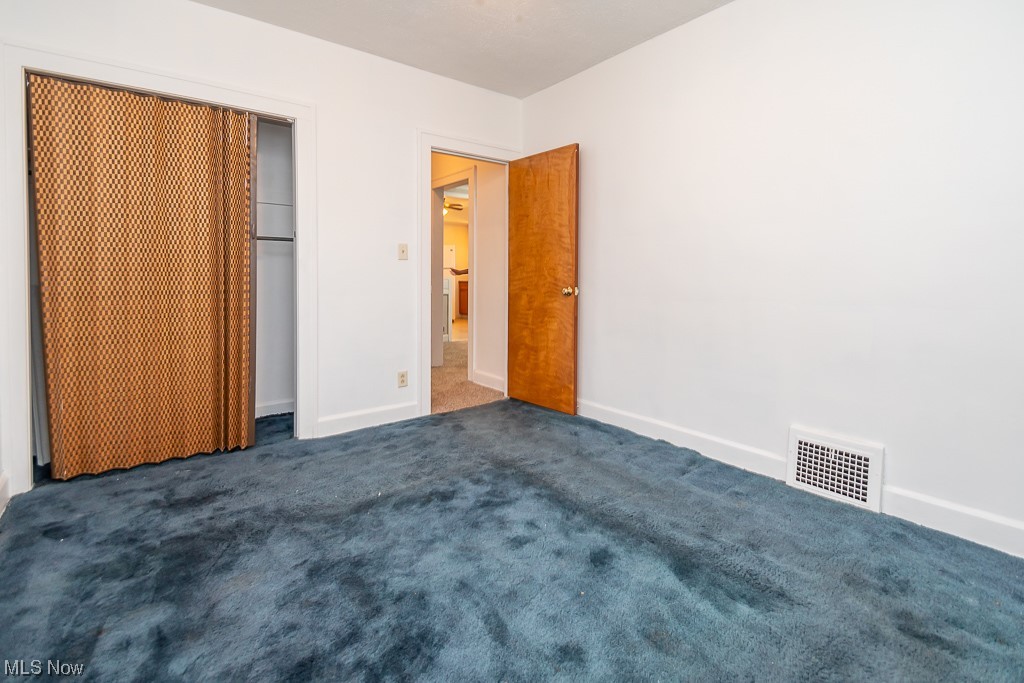 5220 Roseside Avenue Parma, OH 44134 - Photo 19 of 30 Unfurnished bedroom featuring dark carpet and a closet