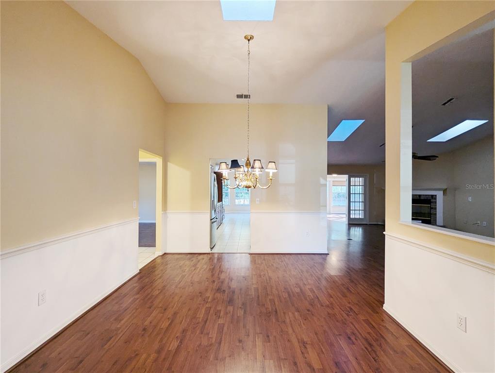 3 Graytwig Court West Homosassa, FL 34446 - Photo 12 of 41 a view of a room with wooden floor and a chandelier
