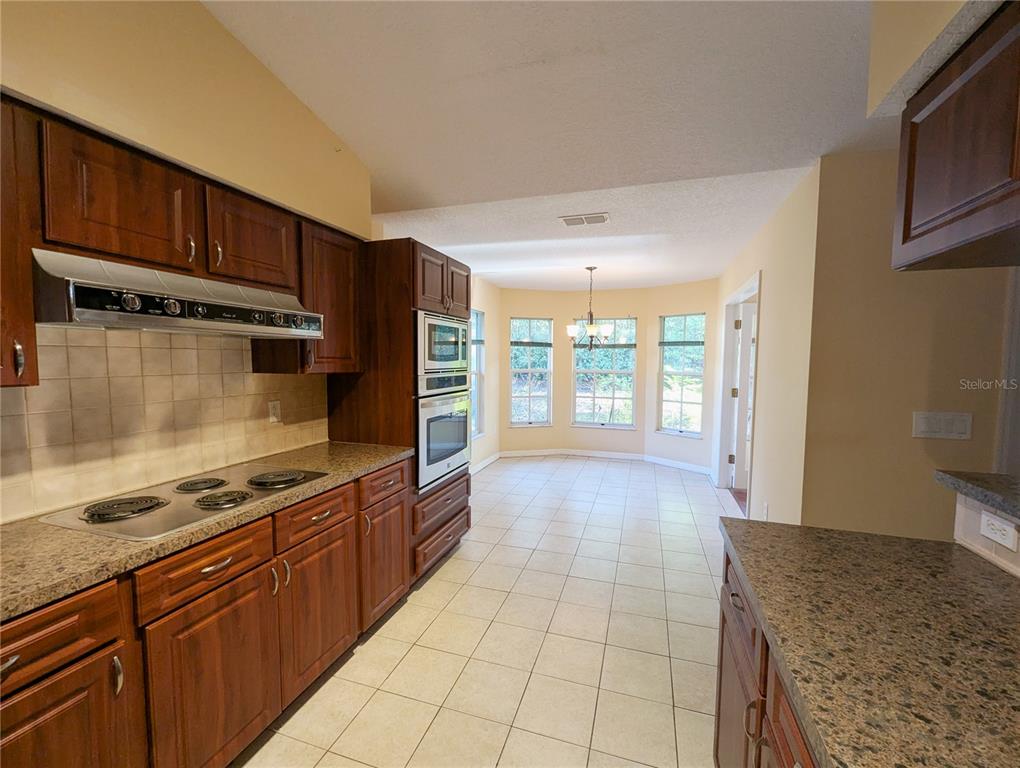 3 Graytwig Court West Homosassa, FL 34446 - Photo 14 of 41 a kitchen with stainless steel appliances granite countertop a stove and a sink