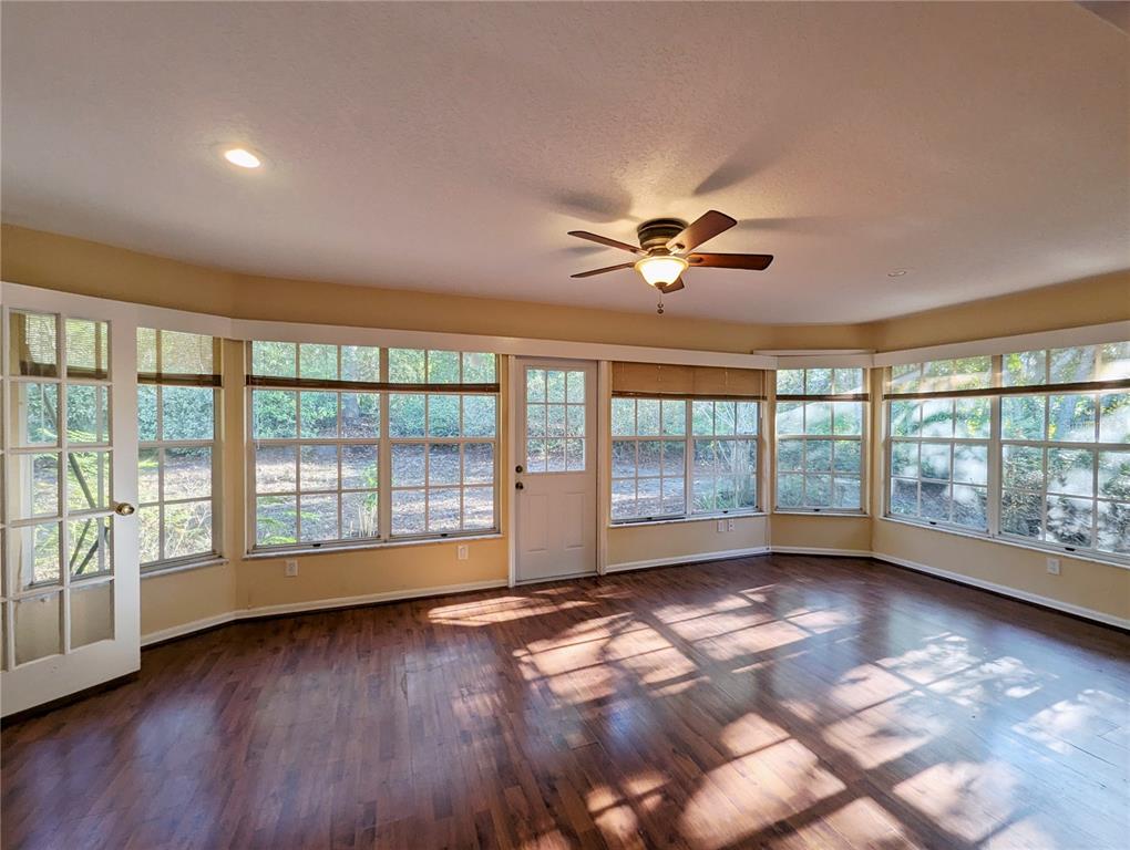 3 Graytwig Court West Homosassa, FL 34446 - Photo 6 of 41 a view of empty room with wooden floor and fan