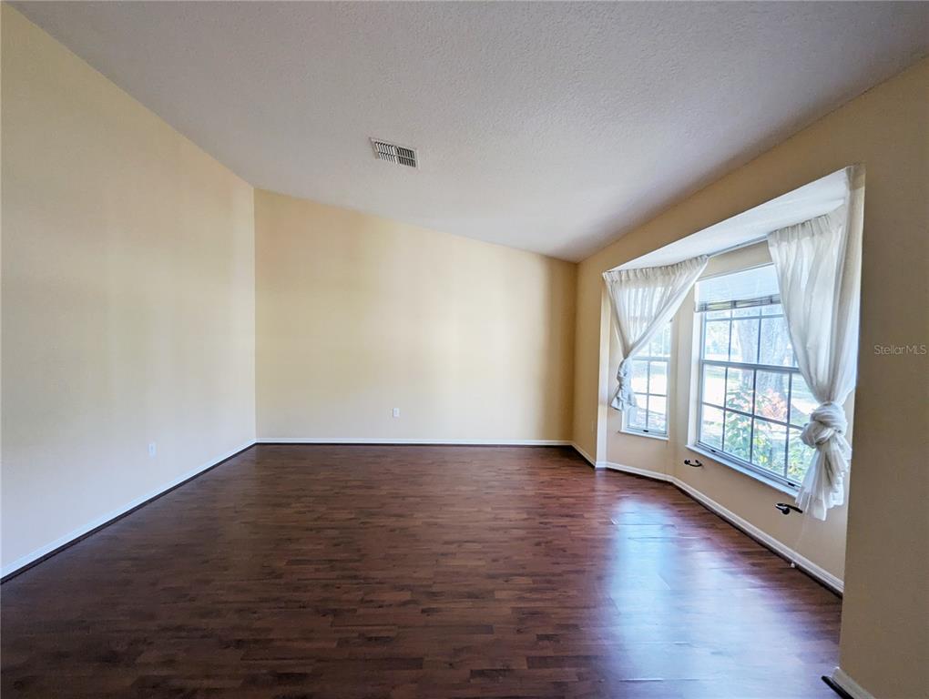 3 Graytwig Court West Homosassa, FL 34446 - Photo 9 of 41 a view of an empty room with glass door and wooden floor