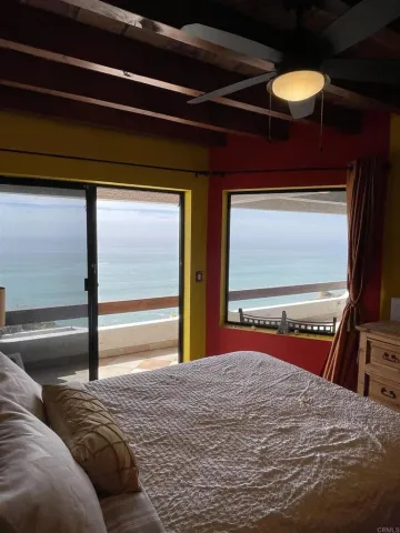 a bedroom with a bed and a large mirror