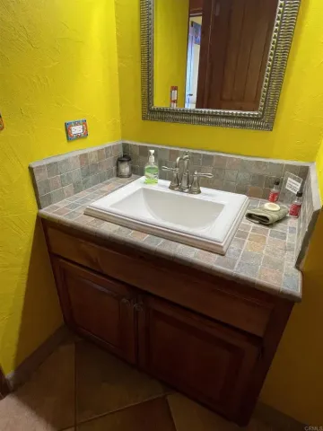 a bathroom with a sink mirror vanity and toilet