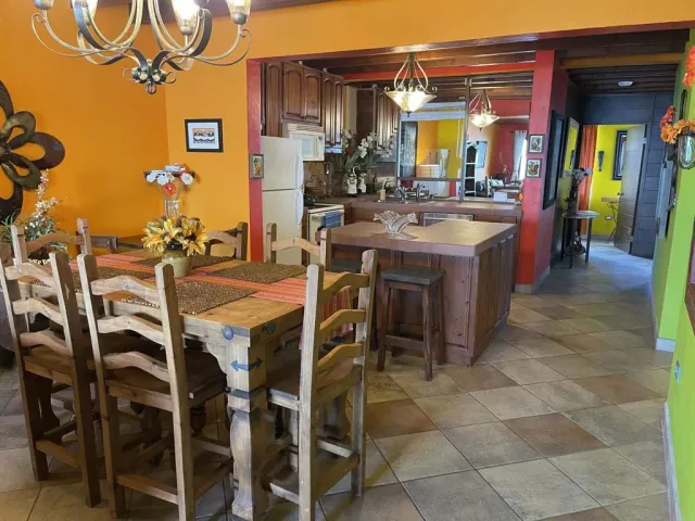 a outdoor kitchen view with a sitting space