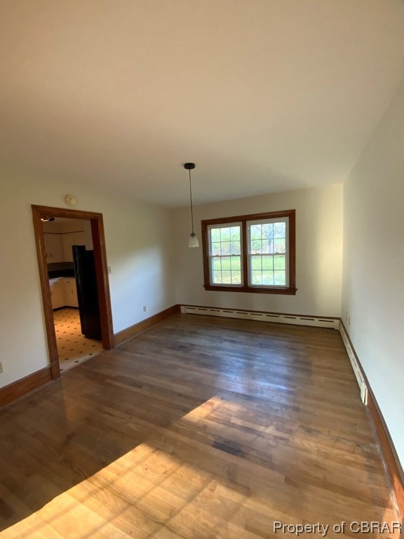 14 Light Street Heathsville, VA 22473 - Photo 3 of 18 Unfurnished room featuring a baseboard radiator and dark hardwood / wood-style floors