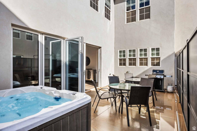 4311 Canterbury Road, Unit F2 Hurricane, UT 84737 - Photo 6 of 18 Outdoor patio featuring a built-in spa with wood-finish siding, bi-fold glass doors, and a concrete patio surface