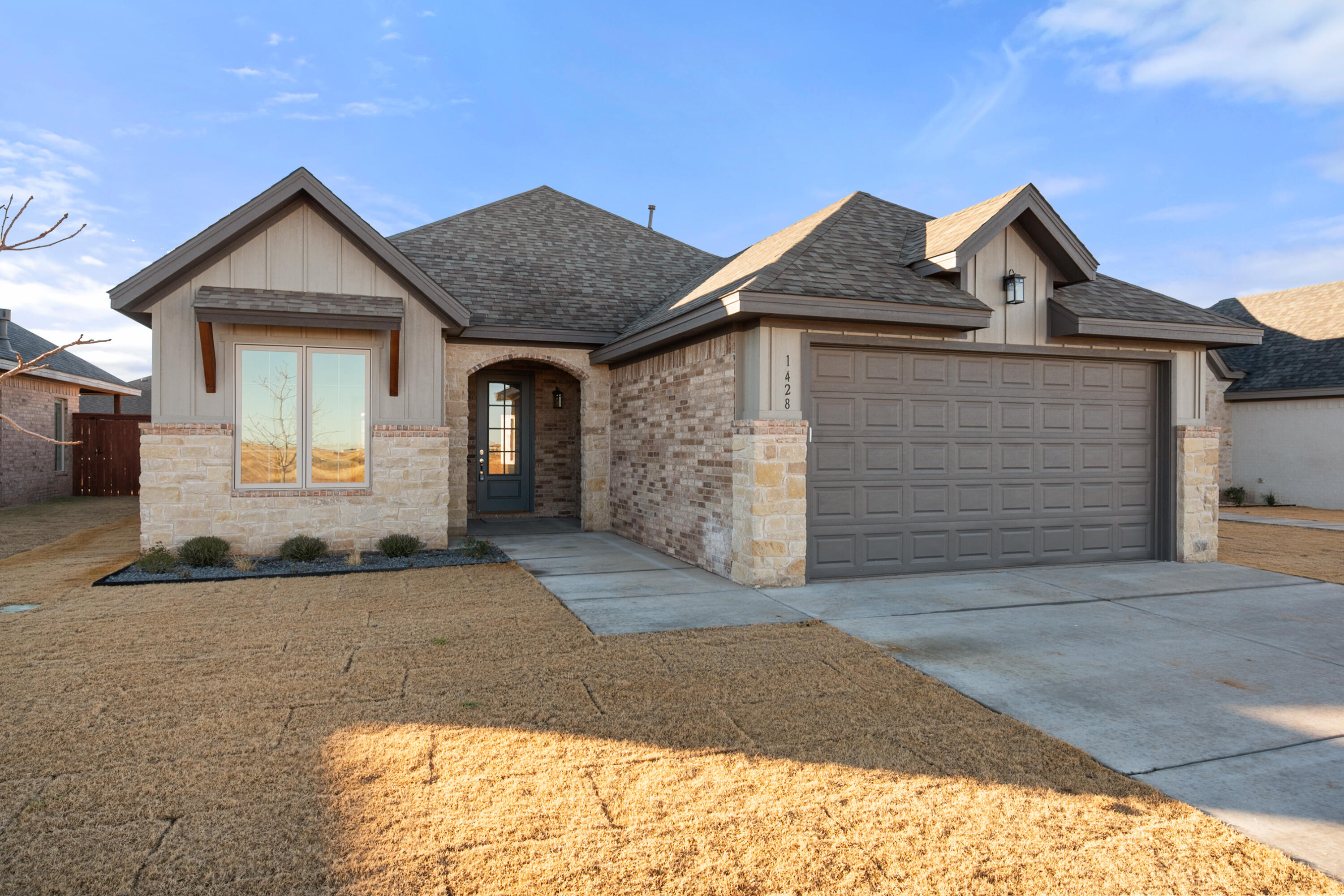 a front view of a house with a yard and garage