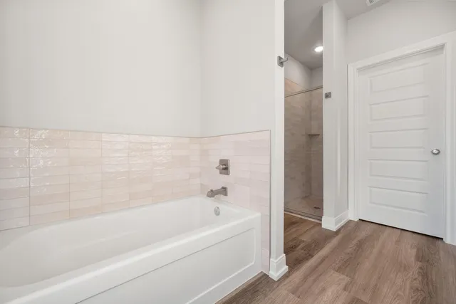 a bathroom with a bathtub and shower