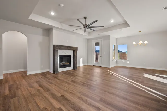 a view of an empty room with a fireplace and a window