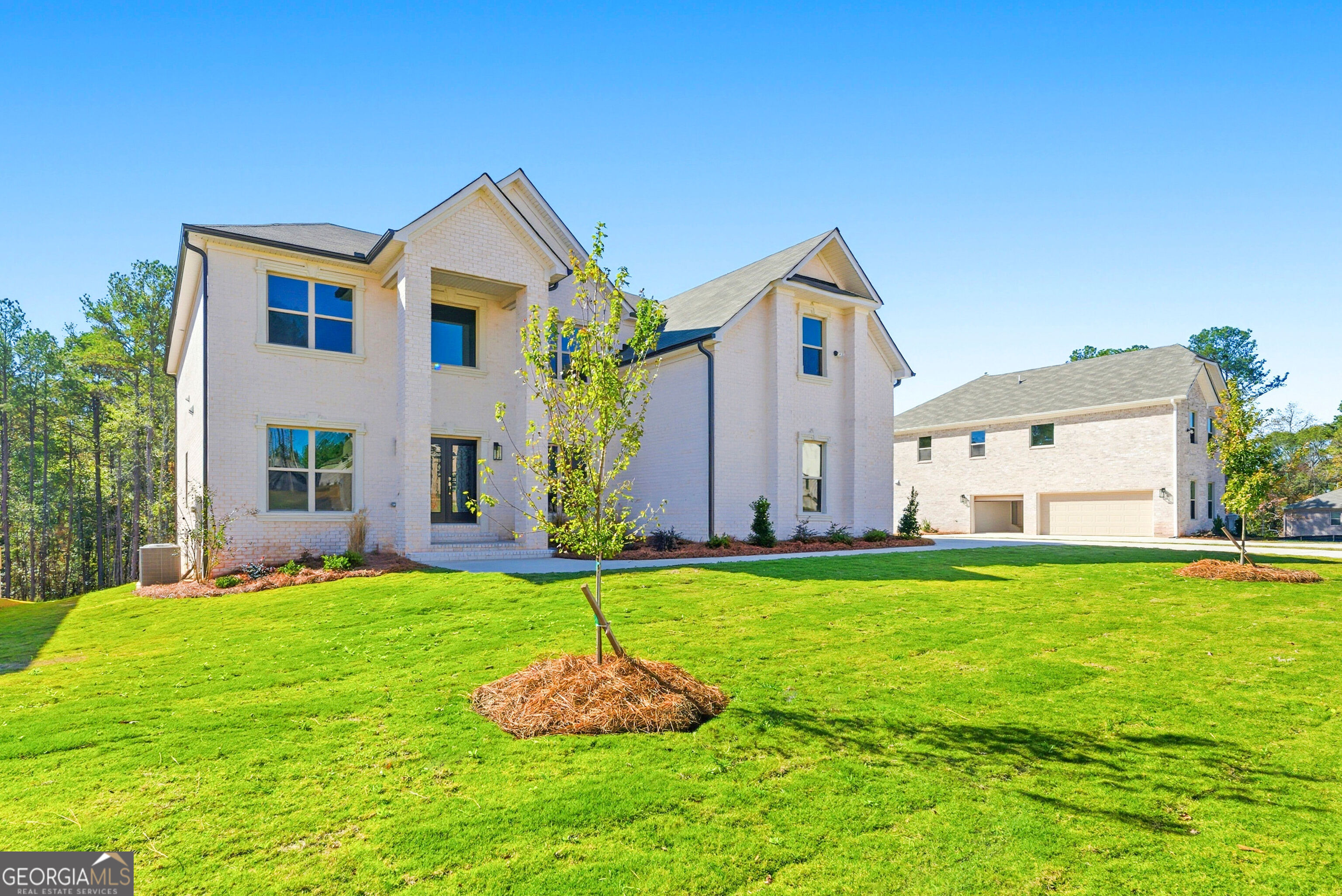 a front view of house with yard and garage
