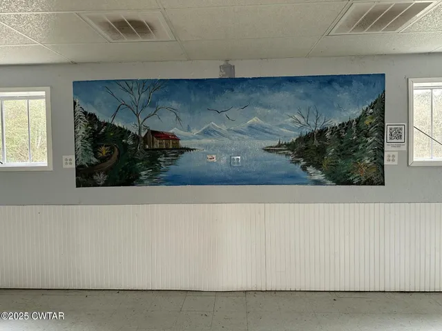 a view of a living room with a fireplace