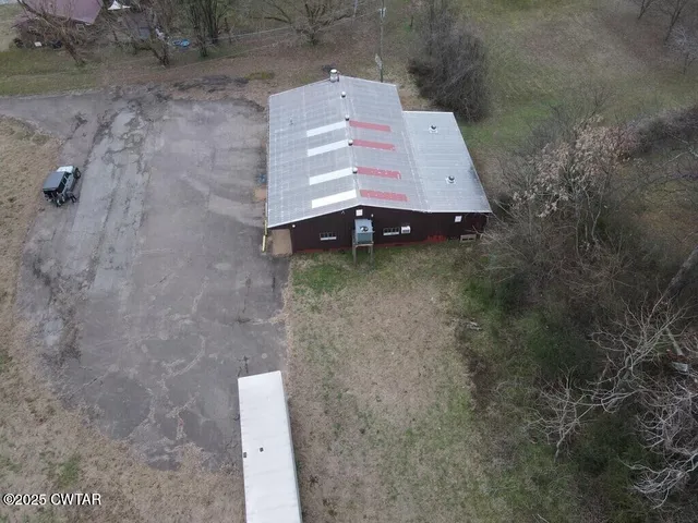an aerial view of a house with a yard
