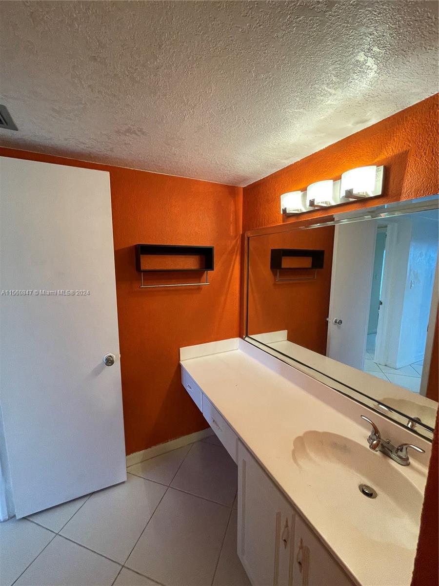 Inverrary Lauderhill, FL 33319 - Photo 13 of 18 a bathroom with a sink and a mirror