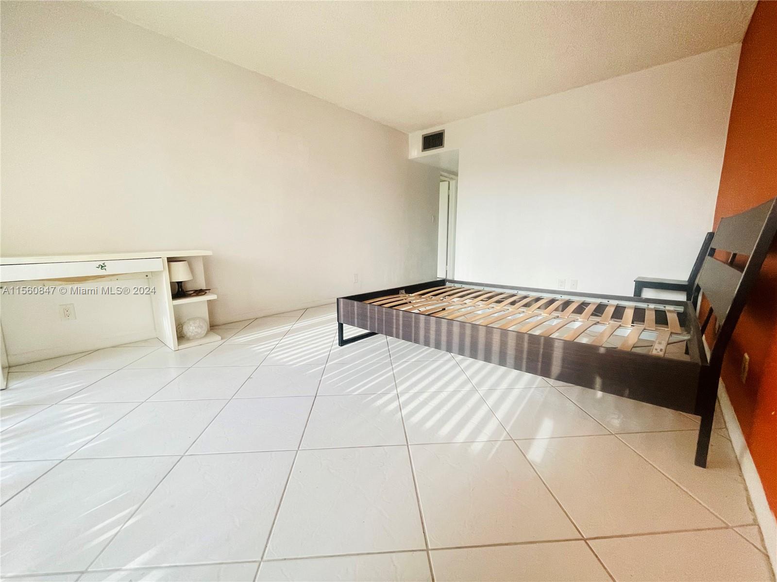 Inverrary Lauderhill, FL 33319 - Photo 16 of 18 a view of a bedroom with a bed and cabinets