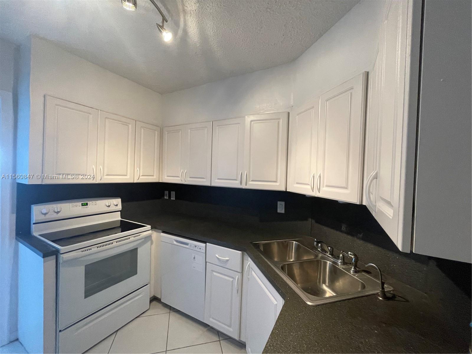 Inverrary Lauderhill, FL 33319 - Photo 3 of 18 a kitchen that has a sink and a stove