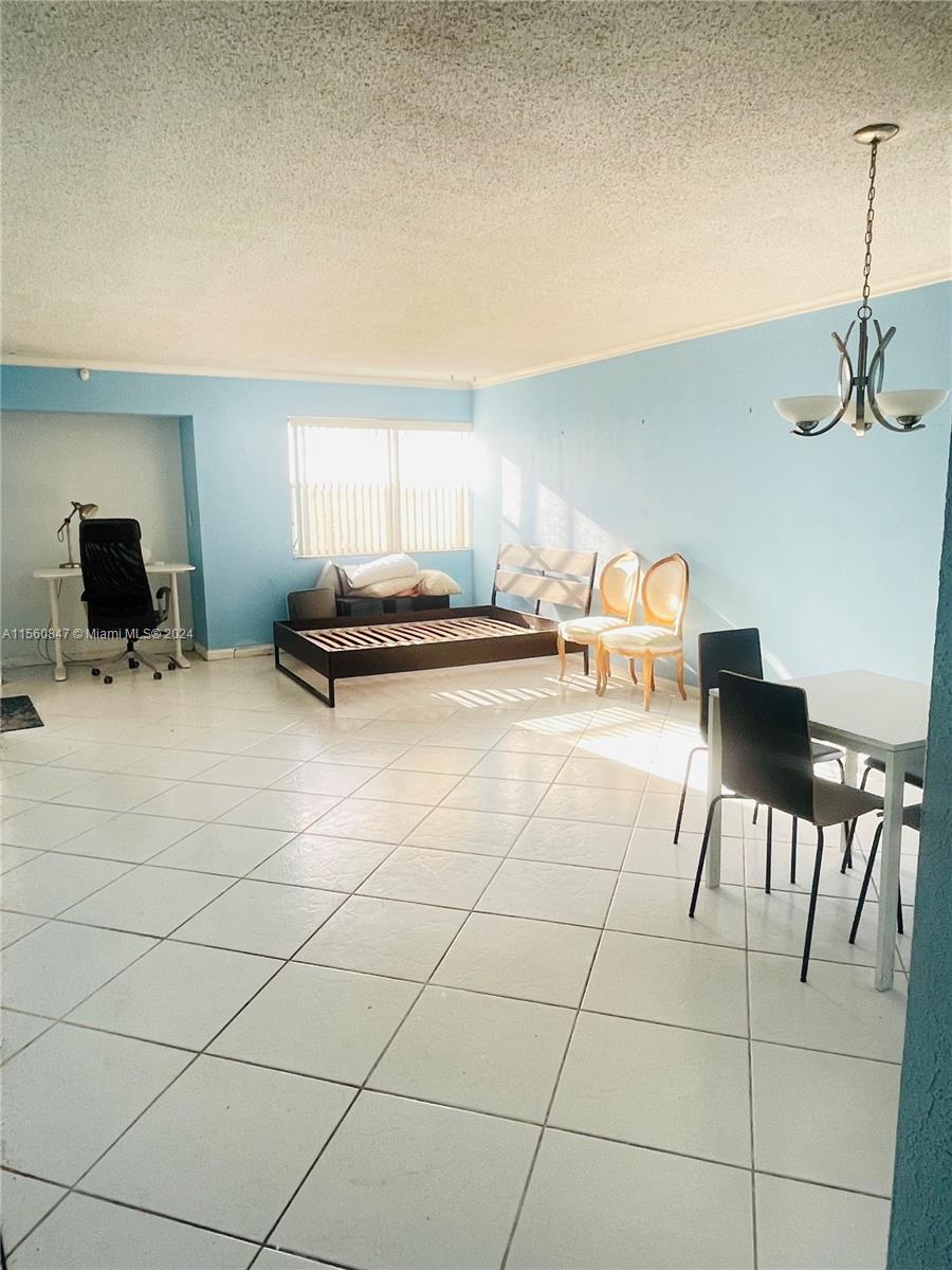 Inverrary Lauderhill, FL 33319 - Photo 5 of 18 a living room with furniture a flat screen tv and lawn chairs