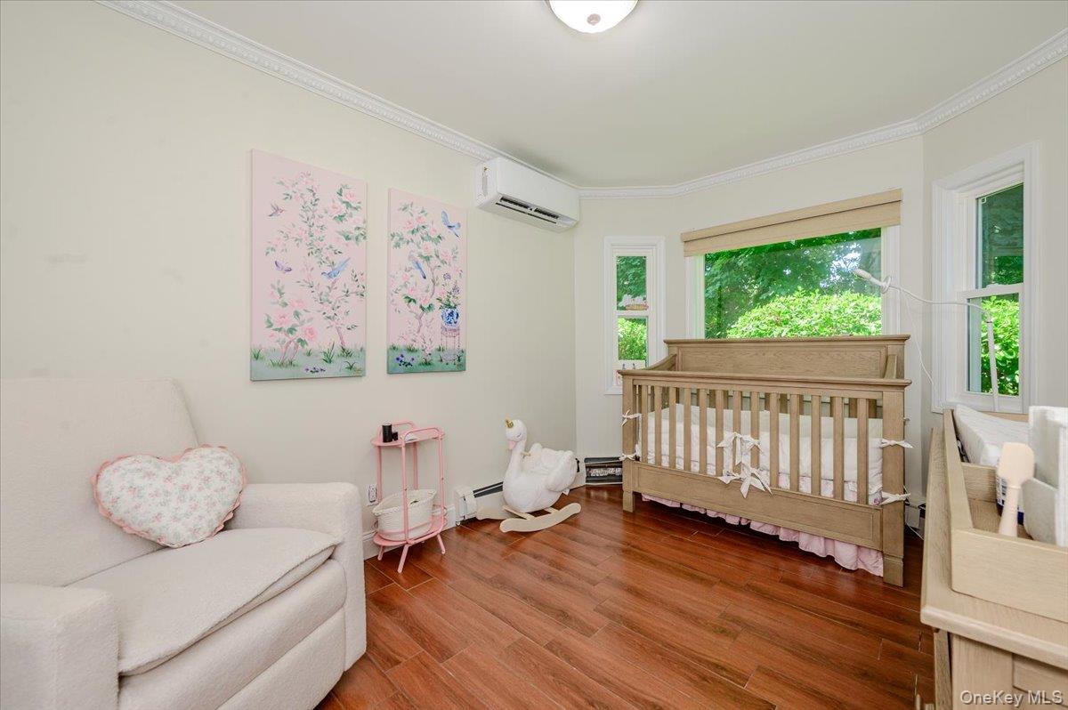 70 Longfellow Road Great Neck, NY 11023 - Photo 20 of 28 a bedroom with furniture and a wooden floor