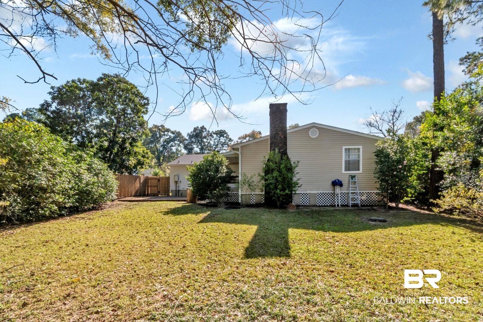 5412 South Norden Drive Mobile, AL 36608 - Photo 12 of 38 Rear view of house featuring a lawn