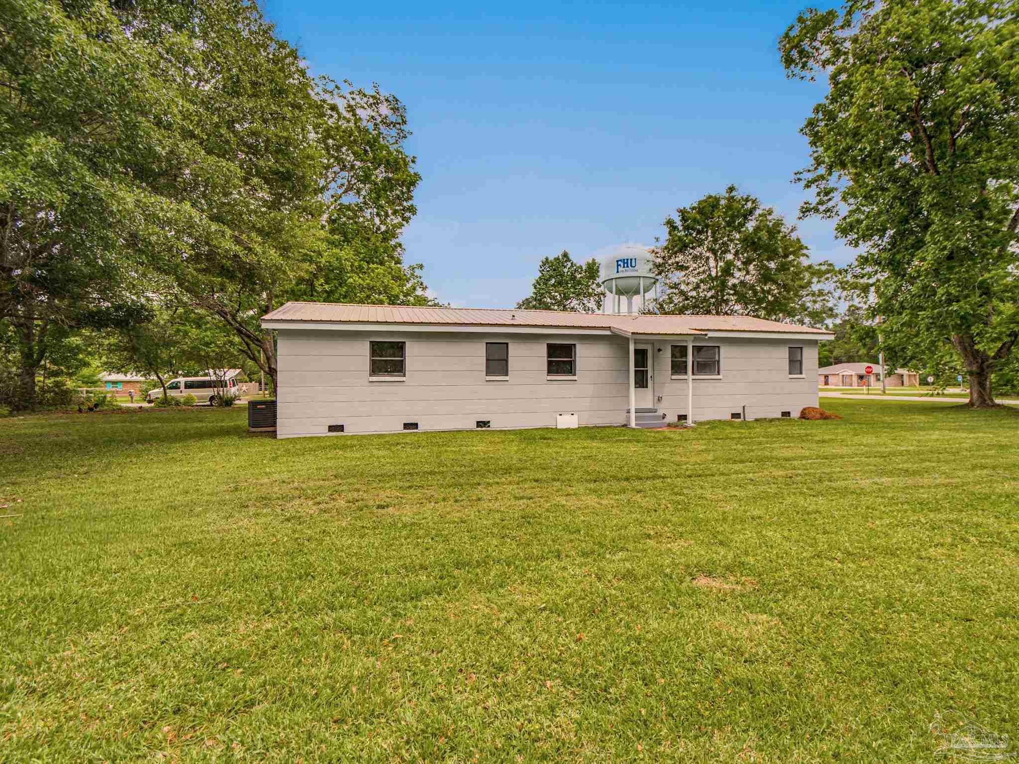 125 Madrid Road Cantonment, FL 32533 - Photo 16 of 16 a view of a house with a backyard