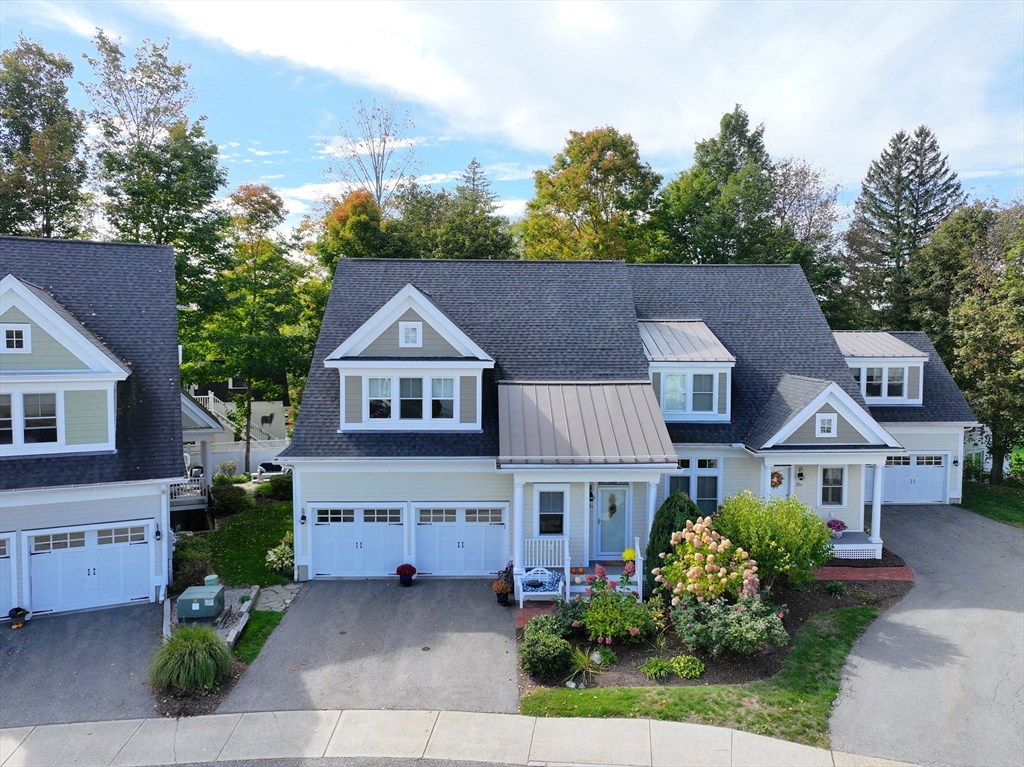 21 A Blacksmith Row, Unit 21 Groton, MA 01450 - Photo 1 of 42 a front view of a house with a garden