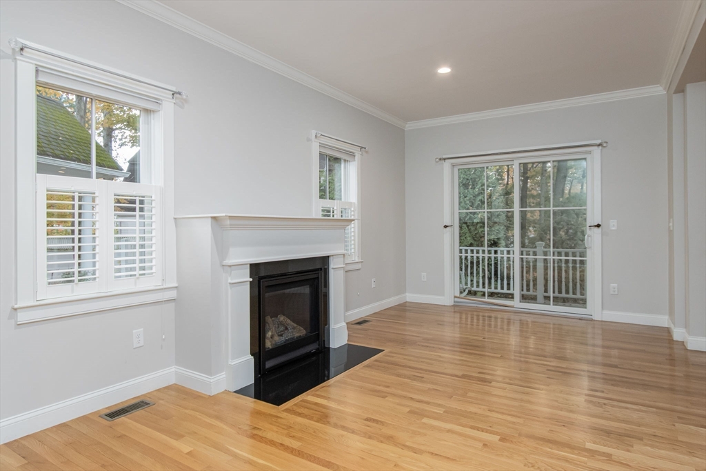 21 A Blacksmith Row, Unit 21 Groton, MA 01450 - Photo 14 of 42 a view of an empty room with wooden floor and a window