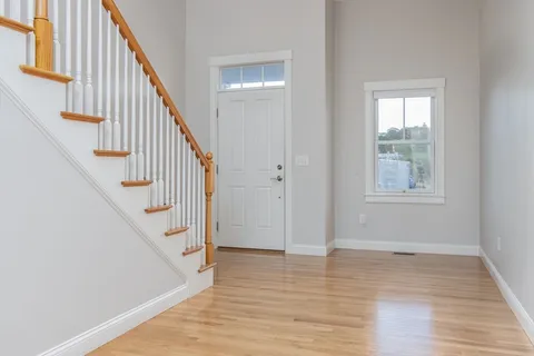 a view of entryway with wooden floor and stairs