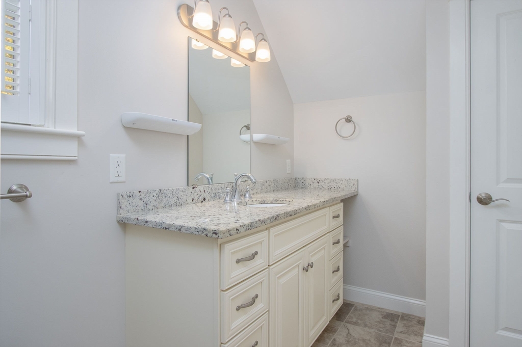 21 A Blacksmith Row, Unit 21 Groton, MA 01450 - Photo 21 of 42 a bathroom with a granite countertop sink and a mirror